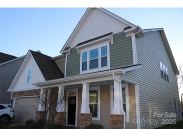 Two-story home with stone accents and a covered porch at 2006 Houle Ln, Charlotte, NC 28214