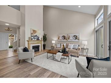 Spacious living room with fireplace, plush seating, and abundant natural light at 203 Riverview Ter, Clover, SC 29710