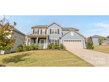 Two-story house featuring a light blue exterior, a two-car garage, and a well-manicured lawn at 3439 Duchess Ave, Indian Land, SC 29707