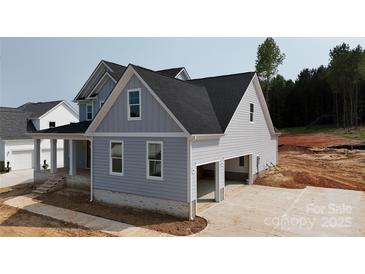 New construction two-story home with gray siding, attached two-car garage and brick foundation at 4251 Candlewood Dr, Sherrills Ford, NC 28673