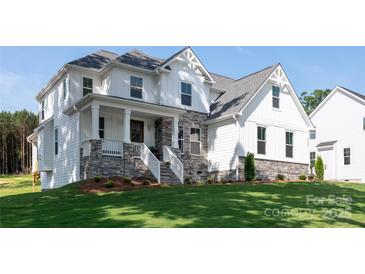 Beautiful two-story home with a stone foundation, covered porch, and lush green lawn at 4257 Candlewood Dr # 7, Sherrills Ford, NC 28673