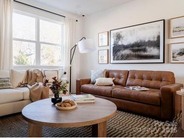 Living room with a comfortable couch and coffee table at 8018 Elevate Ct, Charlotte, NC 28205