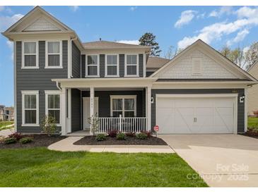 Two-story home with gray siding, white trim, and a two-car garage at 8903 Ansley Park Pl, Huntersville, NC 28078