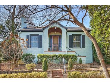 Charming light blue brick home with manicured landscaping and brick walkway at 1204 Buchanan St, Charlotte, NC 28203