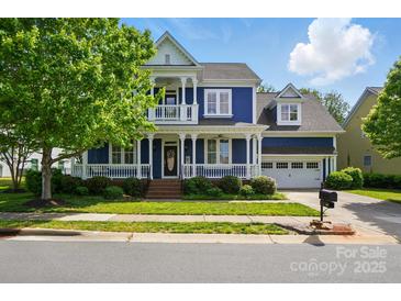 Charming blue two-story home with a welcoming front porch and well-maintained landscaping at 2607 White Pines Ct, Monroe, NC 28112