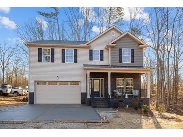 Two-story home with gray and beige siding, a brick facade, and a two-car garage at 5528 Brickstone Dr, Charlotte, NC 28227