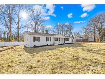 Charming one-story home boasts a manicured lawn and classic white exterior with black trim at 1006 Woodside Dr, Kings Mountain, NC 28086