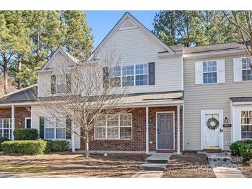 Two-story brick townhome with gray accents and landscaping at 12307 Bluestem Ln, Charlotte, NC 28277