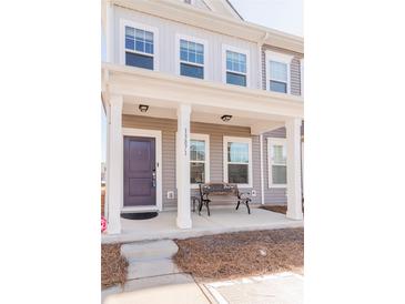 Two-story townhome with a covered porch and bench at 13871 Clayborn St, Midland, NC 28107