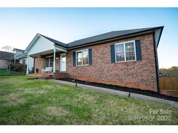 Brick ranch home with front porch and landscaped yard at 300 Pine Meadows Cir, Hickory, NC 28601