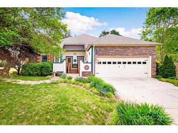 Charming home with colorful accents, brick details, lush front yard, and a two-car attached garage at 3024 Kern Dr, Salisbury, NC 28147