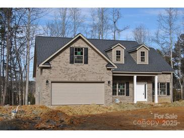 Charming brick home featuring a two-car garage, dormer windows, and a welcoming front porch at 5230 Club View Dr, Concord, NC 28025