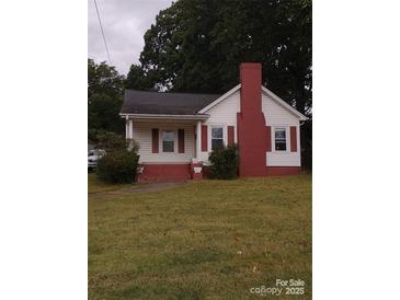Charming white house with red brick accents and a spacious lawn at 903 Belmont Mount Holly Rd, Belmont, NC 28012