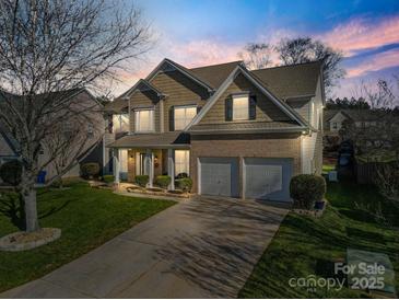 Attractive two-story home with double garage and landscaping at 114 Runningdeer Dr, Mooresville, NC 28117