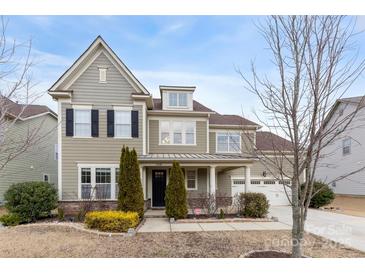 Two-story house with gray siding, black shutters, and a landscaped yard at 11519 Sweet Birch Ln, Charlotte, NC 28278