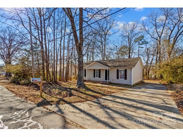 Ranch style home with mature trees and a paved driveway at 116 Westover Ave, Kannapolis, NC 28081