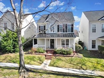 Two-story house with gray siding, dark metal roof, and a front porch at 11615 Kingsley View Dr, Charlotte, NC 28277