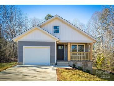 Gray house with white accents, a brown door, and a small porch at 1460 23Rd Sw St, Hickory, NC 28602