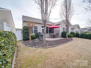 Patio with seating area, grill, and partially fenced yard at 156 Carmen Way, Lancaster, SC 29720