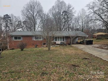 Brick ranch house with a carport and a spacious yard at 2518 Cove Creek Dr, Gastonia, NC 28056