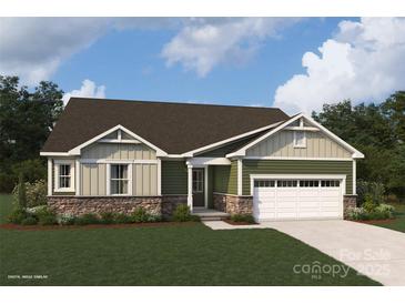 One-story home with green and beige siding, stone accents, and a two-car garage at 2526 Crimson Way, Monroe, NC 28112