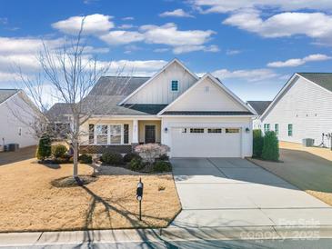 One-story home with neutral siding, brick accents, and a two-car garage at 2706 White Pines Ct, Monroe, NC 28112