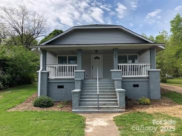 Charming gray house with a front porch and well-manicured lawn at 306 Union St, Maiden, NC 28650