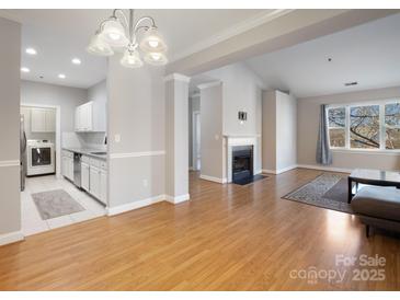 Bright, open living space with hardwood floors, fireplace and ample natural light with attached laundry closet at 5617 Fairview Rd # 9, Charlotte, NC 28209