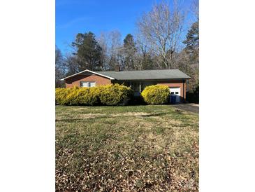 Brick ranch house with attached garage and large yard at 605 S Magnolia St, Mooresville, NC 28115