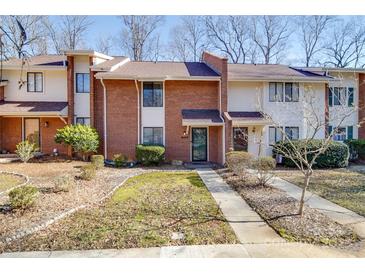 Brick front exterior of townhome with landscaping and walkway at 8465 Ramath Dr, Charlotte, NC 28211