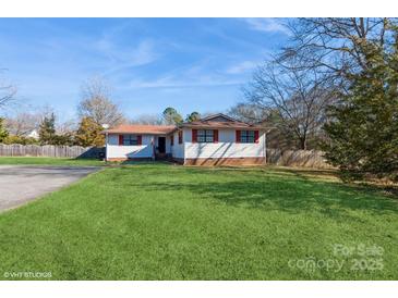 Ranch style home with red shutters, spacious lawn, and driveway at 9938 Sandra Ln, Fort Mill, SC 29707