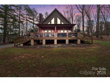 A charming A-frame home with a spacious deck and stone accents at 102 Serene St, Mount Gilead, NC 27306