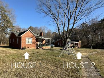 Two cozy, single-story brick homes share a spacious yard, presenting a unique property opportunity at 114 Barker Rd, Dallas, NC 28034