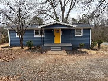 Charming single-story home with blue siding and bright yellow front door at 1464 Bradford Heights Rd, Gastonia, NC 28054