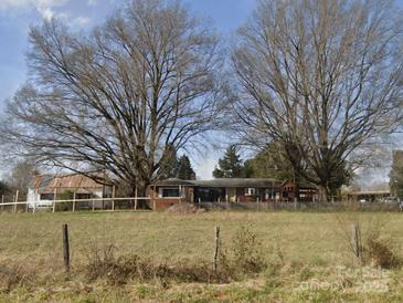 Ranch house with mature trees and fenced yard at 2808 Water Plant Rd, Maiden, NC 28650