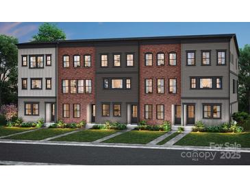 Modern townhome exterior showcasing brick and siding accents, landscaped lawns and black-framed windows at 309 Old Town Village Rd, Waxhaw, NC 28173