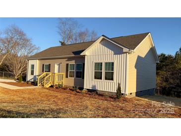 Exterior view of a well-maintained home featuring a side entrance and neatly landscaped front yard at 819 Wellwood Ave, Statesville, NC 28677