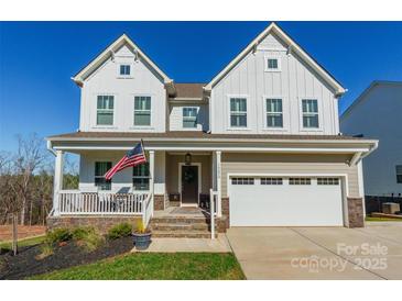 Charming two-story home with a welcoming front porch and an attached two-car garage at 14450 Maritime Dr, Lancaster, SC 29720