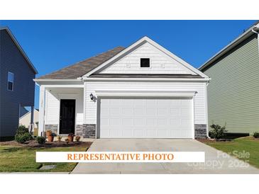 Charming single-Gathering home showcasing a clean white exterior with a prominent two-car garage and a well-manicured lawn at 1630 Troon Dr, Salisbury, NC 28144