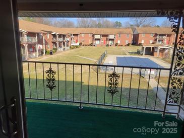 A beautiful view from the apartment showcasing the community courtyard and outdoor pool at 2121 Carriage Woods Ln, Kannapolis, NC 28081