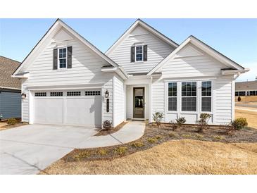 White two-story house with gray shutters and a two-car garage at 4219 Moxie Way, Charlotte, NC 28215