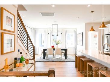 Bright dining room features a modern chandelier and hardwood floors at 8052 Cedarsmith Ct, Charlotte, NC 28217