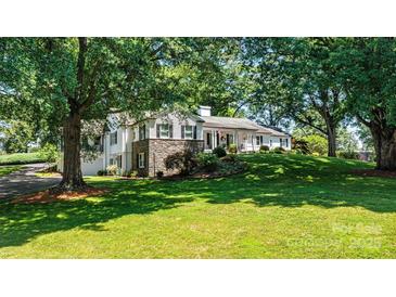 Beautiful white brick home with stone accents, situated on a lush green lawn at 842 North Center St, Hickory, NC 28601