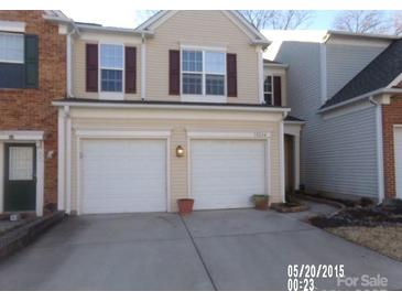 Two-story townhome with two-car garage and landscaping at 10244 Blakeney Preserve Dr, Charlotte, NC 28277