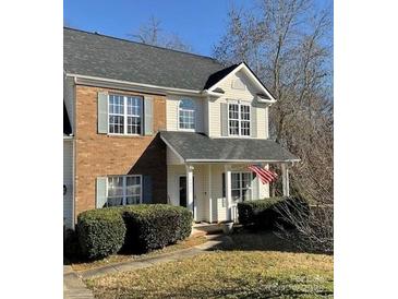 Two-story house with brick and vinyl siding, covered porch, and landscaped yard at 1941 Olsen Ln, Charlotte, NC 28213