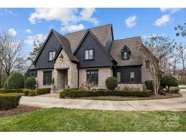 Stunning two-story home with stone and dark siding at 2130 Ferncliff Rd, Charlotte, NC 28211