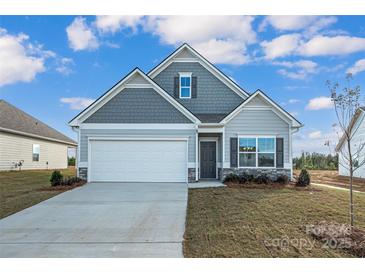 Gray siding ranch home with a two-car garage and landscaped lawn at 2234 Catawba Trace Dr, Catawba, NC 28609