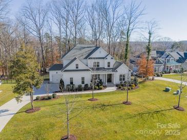 Aerial view of a two-story house with a large backyard and a long driveway at 225 South Shore Dr, Belmont, NC 28012