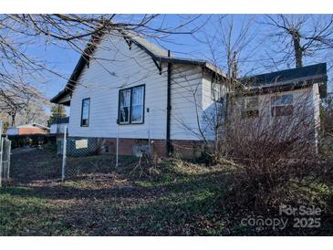 White sided house with a chain link fence and landscaping at 303 N Gaston St, Kings Mountain, NC 28086