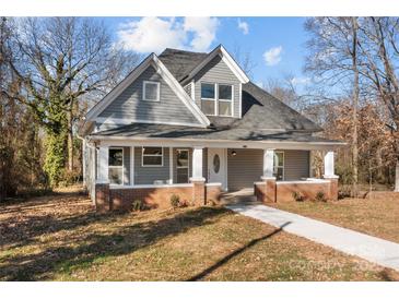 Charming craftsman home with gray siding, brick accents, and a welcoming front porch at 336 3Rd Se St, Hickory, NC 28602